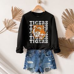 This makes the perfect vintage school spirit Tigers sweatshirt! This tigers sweatshirt is great for showing your school spirit! This distressed vintage tiger design is perfect on the popular Gildan brand sweatshirt. This vintage style sweatshirt will keep you warm throughout the school season!  A pre-shrunk, classic fit sweater that's made with air-jet spun yarn for a soft feel and reduced pilling. ** P R O D U C T **  - 50% cotton, 50% polyester  - Pre-shrunk  - Classic fit  - Direct to Garment print (no stencils or vinyl which means it will last a lot longer)   - Printed and Shipped in the USA  - Due to different monitor screens colors may vary ** S I Z I N G **  - Consult size chart in listings for measurements  - Sizing is Unisex for all tees, runs true to size  - For an oversized fit, Varsity Long Sleeve T-shirt For School, Collegiate Graphic Print Sweatshirt For College, Retro College Sweatshirt With Screen Print, Retro College Sweatshirt With Text Print, Retro College Screen Print Sweatshirt, Varsity Sweatshirt With Graphic Print For School, College Style Game Day Sweatshirt With Graphic Print, Varsity Graphic Print Sweatshirt For School, School Spirit Fall Tops With Letter Print