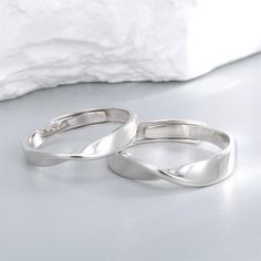 Product Description: Unique Mobius Design: Our S925 Sterling Silver Mobius Strip Couple Rings feature a distinctive twist that symbolizes infinity and unity. This elegant and modern design is perfect for couples who appreciate both style and meaning in their jewelry. Adjustable Fit: Designed with an open band, these rings offer an adjustable fit to ensure comfort and convenience for both men and women. The versatile sizing makes them an ideal choice for any finger size. Premium Material: Made from high-quality S925 sterling silver, these rings are hypoallergenic and built to last. The sterling silver construction guarantees a brilliant shine and enduring beauty, suitable for everyday wear. Perfect for Long-Distance Relationships: These rings serve as a constant reminder of your unbreakable Minimalist Silver Couple Rings For Promise, Couples' Sterling Silver Jewelry In Silver, Silver Open Ring Couple Rings, Silver Open Ring For Couples, Silver Stackable Rings With Modern Twist For Wedding, Silver Sterling Couple Rings With Open Band, Sterling Silver Open Couple Rings, Silver Sterling Open Band Couple Rings, Sterling Silver Couple Promise Rings With Open Band