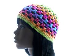 a mannequin head wearing a multicolored crocheted beanie hat