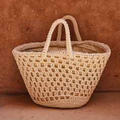 White Bohemian Open Weave Straw Bag, Eco-friendly White Open Weave Beach Bag, White Straw Basket Bag With Braided Handles, White Basket Straw Bag With Braided Handles, Beige Basket Straw Bag For Market, Natural Basket Beach Bag With Braided Handles, White Natural Fiber Basket Beach Bag, White Crochet Basket Bag For Shopping, Eco-friendly Cream Straw Basket Bag