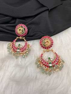 Peacock Red Green Jadau Kundan Chandballi Earrings screwback earringsColor : GoldenSize : Length :2.75 Inches; Weight :25 grams eachStones : Green Jadau Kundan Pearls Green Emerald Beads Traditional Red Pearl Earrings For Party, Festive Chandbali Temple Jewelry Plug Earrings, Chandbali Temple Jewelry Plug Earrings For Festive Occasions, Chandbali Jeweled Temple Jewelry Bridal Earrings, Temple Jewelry Chandbali Plug Earrings For Festive Occasions, Jeweled Chandbali Bridal Earrings In Temple Style, Jeweled Chandbali Bridal Earrings In Temple Jewelry Style, Temple Jewelry Style Jeweled Danglers For Festivals, Temple Jewelry Styled Jeweled Danglers For Festivals