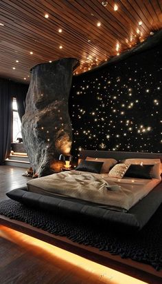 a large bed in a room with stars on the wall and wooden ceiling above it