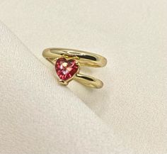 Our Heart Shaped Ruby Ring embodies a bright red ruby crystal as the main stone throughout its gold band ✔ Gold Plated 925 Sterling Silver ✔ Hypoallergenic ✔ Tarnish Free ✔ High Quality CARE: Our jewelry can handle a normal amount of contact with water and sweat, but we suggest limited contact for longer durability. We take pride in using high quality materials for those pieces that are not stainless steel or gold filled but we ask that you try to avoid contact with harsh chemicals that can mess Red 14k Gold Heart Ring For Promise, 14k Gold Red Heart Ring For Promise, Red 14k Gold Heart Promise Ring, Gold Heart-shaped 14k Gold Ruby Ring, Gold Heart Ring With Gemstone For Valentine's Day, Red Heart Birthstone Ring In 14k Gold, Gold Gemstone Ring For Valentine's Day, 14k Gold Heart-shaped Ruby Ring, Gold Heart-shaped Ruby Ring In 14k Gold