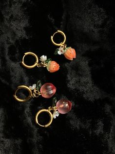 These glass fruit earrings pair perfectly with a picnic or a sundress on a sunny day! They're great for bringing a bit of sweetness and sunshine into any day. The colorful glass fruits and leaves paired with gold hoops keep these earrings looking elegant while also being lots of fun! 🍑 I've included both glass peaches and resin/plastic peach-colored blossoms. Choose your favorite - or they look great paired together! Each earring also has a little flower and leaf bead, and the charms are attached to small gold chunky hoops that have a leverback closure. These earrings are light and comfortable to wear throughout the day, and look great stacked together or paired with other earrings if you have multiple ear piercings! Do you like berries more? I also similar have strawberry, blackberry, an Vintage Summer Hoop Earrings, Flower Shaped Hoop Earrings For Summer Gifts, Summer Gift Cherry Earrings, Peach Earrings For Summer Gift, Trendy Flower Hoop Earrings For Summer, Orange Small Hoop Earrings For Summer, Summer Pink Earrings With Fruit Design, Summer Orange Small Hoop Earrings, Summer Fruit Design Drop Earrings