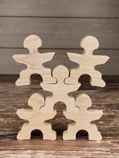 the wooden puzzle pieces are arranged on top of each other, with one piece missing