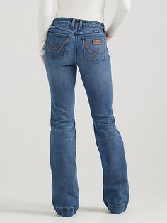 THE TROUSER: THE ULTIMATE IN WOMEN'S RETRO® JEANS Like all Wrangler Retro® jeans, our Mae wide-leg trouser jean is marked by its Western authenticity, making it a go-to style for cowgirls everywhere. With its contour waist and mid-rise fit, these women's trouser jeans are made to fit comfortably while they flatter all your curves. With more room at the knee and a gradual opening down the leg, the Mae wide-leg trouser gives you the room you need to stay active and in style. Wrangler Bootcut Jeans Women, Women’s Wrangler Jeans, Wrangler Flare Jeans, Wide Leg Jeans Western, Wrangler Jeans Womens, Kimes Ranch Jeans, Wrangler Jeans Women's, Womens Trouser Jeans, Denim Jeans Women