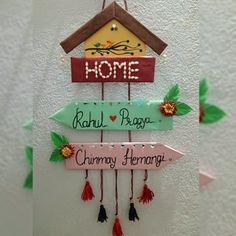 there are three signs hanging on the wall with name tags attached to them, one has a birdhouse and the other is a home