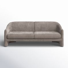 a gray couch sitting on top of a white floor