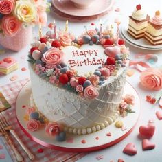 a heart shaped birthday cake with candles and flowers on the top is surrounded by confetti