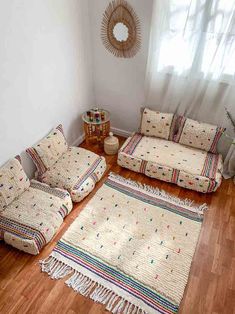 a living room with couches and rugs on the floor