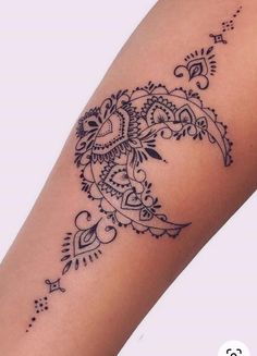 a woman's arm with an intricate tattoo design on the left side of her leg