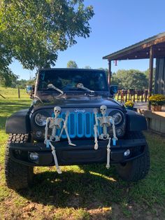 a jeep with skeleton decorations on the hood