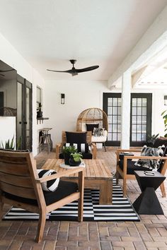 a living room filled with furniture and a fan on top of a ceiling mounted fan