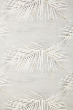 a white and gold wallpaper with palm leaves on it