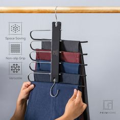 a person is hanging folded shirts on a clothes hanger with space saving clippings