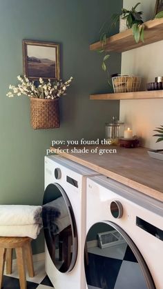 a washer and dryer sitting next to each other in a room with green walls