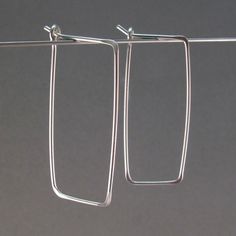 Rectangular Hoops -choose your metal -sterling silver, argentium sterling, 14kt yellow gold filled, 14kt rose gold filled, grey niobium -fits standard piercings -pair -handmade by me -choose length -photos are 1.25 INCH X .5 INCH -nickel free hypoallergenic These earrings are handmade by me with hard temper wire to ensure they retain their shape. Polished and rounded earring ends prevent irritation when worn. Simple earrings with spring in the wire so they keep their shape , providing you with a Earrings Mens, Mens Earrings, Silver Wire Earrings, Rectangular Earrings, Interchangeable Earrings, Argentium Silver, Minimal Modern, Men Earrings, Sterling Silver Hoop Earrings