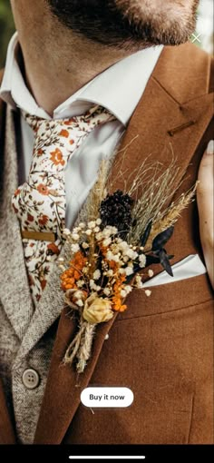 a man wearing a suit and tie with flowers in his lapel flower bouquet on his lapel