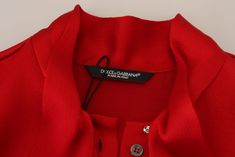 Indulge in the epitome of Italian craftsmanship with this stunning red blouse from Dolce & Gabbana. Gorgeous new with tags, this 100% Authentic piece is a perfect blend of style and sophistication. Featuring an ascot collar and a fitted design with long sleeves, this top is crafted from a luxurious mix of acetate and viscose for a comfortable and flattering fit. Complete with subtle logo details, it’s a must-have for any fashion-forward wardrobe. Made in Italy, it represents the essence of luxur Red Ascot, Red Blouse, Elegant Red, Denim Jacket Men, Dolce E Gabbana, Collar Blouse, Red Blouses, Dolce & Gabbana, Jean Coat