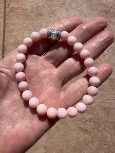 Perfect genuine AAA+ soft pink Peruvian Opal 8mm rounds and a crystal bead to top. Sized at size 7, it will fit smaller wrists and accommodate up to 7 1/2. Pink Stretch Bracelet With Gemstone Beads, Spiritual Pink Beaded Hypoallergenic Bracelets, Healing Pink Bracelets With Spacer Beads, Spiritual Pink Round Stretch Bracelet, Pink Opal Round Beads Bracelet, Pink Faceted Beaded Bracelets, Pink Round Spiritual Beaded Bracelets, Peruvian Opal, Opal Bracelet