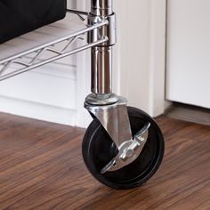 an image of a metal dolly with wheels on the floor in front of a door