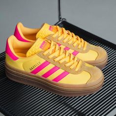 Highlights Runs Big, Size Down 1/2 Size Design: Iconic Gazelle Silhouette With Bolder Details Serrated 3-Stripes And A Metallic-Gold "Gazelle" Classic Lace Closure With A Premium Soft Suede Upper Durability & Traction: Tripled-Stacked Platform Rubber Outsole Adds Elevated Style And Traction Additional Details: Runs Big, Size Down 1/2 Size Pink And Yellow Gazelle, Yellow Leather Sneakers For Spring, Gazelle Platform, Gazelle Bold Shoes, Pink Gazelles, Adidas Sleek, Gazelle Bold, Adidas Shoes Originals, Bold Shoes