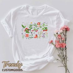 "Wildflowers Cottagecore Shirt,Floral Women Gift Tee,Gift For Mom,Flowers Graphic Shirt,Botanical Shirt,Nature Lover Shirt,Gardener Shirt  ----- How To Order ----- 1-) Please, check and review all the photos. 2-) Choose your t-shirt size and color. *Different styles of shirts may have different shades of same color choice due to different manufacturer brands. *For this reason, we recommend you to match shirts from the same styles if you want precisely matching colors (ex. Unisex, V-necks, Toddle White Crew Neck Tops With Plant Print, Cottagecore Printed Crew Neck T-shirt, White Botanical Shirt For Summer, Botanical Green Tops With Plant Print, Green Botanical Print Tops, Spring White Printed Top, White Botanical T-shirt With Floral Print, White T-shirt With Botanical Print, White Botanical Floral Print T-shirt