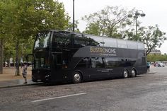 a double decker bus is parked on the side of the road