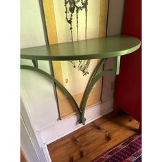 a green shelf sitting on top of a wooden floor