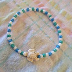 My 12 Yr Old Daughter Is Making Braclets And Wants To Share Her Designs With You. This Braclet Has Blue, Green, And White Beads With A Turtle Accent. How Cute Would This Be To Add It To Your Collection!!! Under The Sea Turtle, Turtle Bracelet, A Turtle, Bracelet Ideas, White Beads, Sea Turtle, Green And White, Under The Sea, Womens Jewelry Bracelets