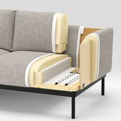 a couch that has its back open and is sitting on a table