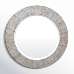 a round mirror on the wall with white and brown wood grains inlayed around it