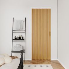 a white room with a wooden door and black shelf on the wall next to it