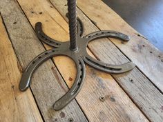 a metal object sitting on top of a wooden table