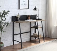 a desk with a book shelf next to it and a potted plant in the corner