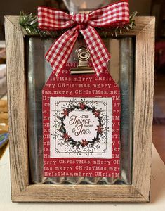 a wooden frame with a red and white christmas ornament