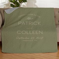 a blanket that says patrick and collien on it with a potted plant in the background