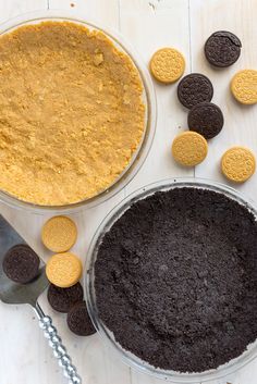 an oreo cookie crust in a glass pie dish next to a bowl of cookies