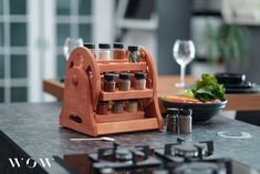 a wooden spice rack sitting on top of a counter