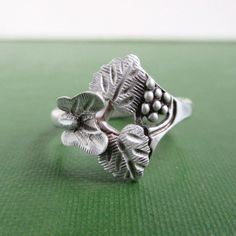 A vintage sterling silver black hills ring with 3D butterfly, leaf and berry design.  Marked "C.CO. STER".  A little vintage darkness and wear.  A size 6 on my ring sizer. Please check out my store with similar things added almost daily. Remember, shipping for additional items is always free. Vintage Adjustable Sterling Silver Butterfly Ring, Adjustable Vintage Sterling Silver Butterfly Ring, Vintage Sterling Silver Butterfly Ring For Anniversary, Vintage Flower Ring Stamped 925 For Anniversary, Vintage Nickel-free Flower Ring For Anniversary, Nickel-free Vintage Flower Ring For Anniversary, Vintage Flower Ring Stamped 925, Vintage Silver Nickel-free Flower Ring, Adjustable Vintage Sterling Silver Flower Ring