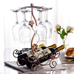 PRICES MAY VARY. This tabletop wine rack holds 2 bottle and 6 glasses. It is sturdy and will not tip if glasses are placed on one side or is not filled completely. The distance between base and curved arms is 8.6 in. Wine, champagne, and martini glasses, of different shapes & sizes, fit nicely on this glasses drying rack. This rustic wine rack is perfect for displaying glasses as well as for air drying them. Great decorative way to keep wine glasses. Doesn't take up much counter space. Package l Wine Glass Tree Holder, Glassware Rack, Wine Rack With Glass Holder, Countertop Wine Rack, Glasses Display, Table Top Wine Rack, Rustic Wine Racks, Metal Wine Rack, Wine Rack Cabinet