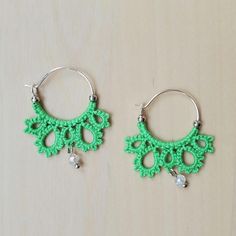 These delicate earrings were made by shuttle tatting directly onto 20mm ear wires using Scheepjees Sugar Rush mercerized cotton thread in Spring Green. Small metal beads keep the thread from sliding off the hoops, and small glass beads add a fun dangle element. (Original pattern) Green Crochet Jewelry, Green Macrame Earrings As A Gift, Green Macrame Earrings For Gift, Green Bohemian Hoop Earrings Hypoallergenic, Bohemian Green Hoop Earrings Hypoallergenic, Handmade Adjustable Green Hoop Earrings, Green Macrame Dangle Earrings, Adjustable Handmade Green Hoop Earrings, Bohemian Green Hypoallergenic Hoop Earrings