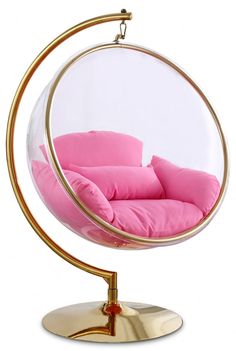 a pink chair in a glass ball on a metal stand with a gold plated base