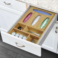 an open drawer in a kitchen filled with personal care items