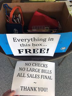 a hand holding a sign that says everything in this box is free no checks, no large bills all sales final thank you