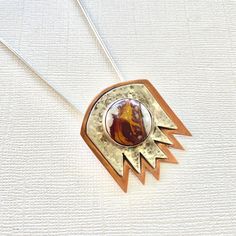 The silver pendant necklace for women is a piece of handmade silver jewelry, featuring a mixed metal design for a unique look. This authentic Native American statement necklace includes a jasper stone, making it both stylish and meaningful. 🪶 𝗠𝗔𝗧𝗘𝗥𝗜𝗔𝗟𝗦 + 𝗗𝗜𝗠𝗘𝗡𝗦𝗜𝗢𝗡𝗦 ❯  Sterling Silver, Copper, Imperial Jasper ❯  Pendant measures 1-3/8 inches wide  x  1-1/4 inches high ❯  18-inch Sterling Silver Chain + Matching Lobster Claw Clasp 🪶 𝗦𝗧𝗢𝗡𝗘 + 𝗘𝗟𝗘𝗠𝗘𝗡𝗧 𝗘𝗡𝗘𝗥𝗚𝗬 ❯  SILVER is known to deflect negativity and attract money ❯  COPPER enhances positive energy flow ❯  JASPER embodies peace, calm and tranquility 🪶 𝗬𝗢𝗨 𝗠𝗜𝗚𝗛𝗧 𝗟𝗜𝗞𝗘 ❯  Dentalium + Abalone Earrings (photo 9) -- lorenlavinedesigns.etsy.com/listing/924779630 ♻️  𝗘𝗖𝗢-𝗙𝗥𝗜𝗘𝗡𝗗𝗟𝗬 𝗦𝗛𝗢𝗣 Mixed Metal Necklace, Abalone Earrings, Handmade Silver Jewelry, Imperial Jasper, Mixed Metal Jewelry, Metal Necklace, Jewelry Statement, Jasper Pendant, Silver Jewelry Handmade