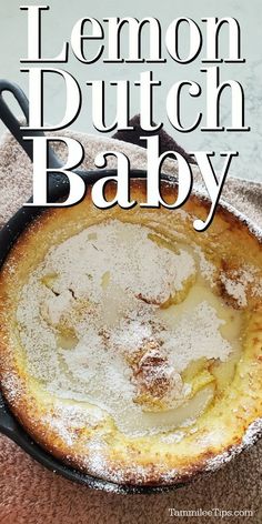 lemon dutch baby in a cast iron skillet with powdered sugar on the top