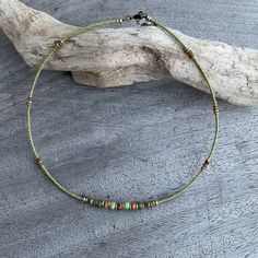 ✦Delicate and eye catching light olive green choker style single strand necklace with beige and turquoise green feature beads at center, I have added brass spacer beads to enhance the necklace. At back of the necklace I have used tiny 2mm seed beads I have created this piece with inspiration from tribal cultures around the world, while adding a modern  unique feel. ✦Size beads 4x4mm, 3x3mm 2x2mm. ✦Length of short strand 40.5cm (16") fitted with a lobster clasp and 45mm extension chain. ✦This nec Hippie Green Round Beads Jewelry, Hippie Green Round Beaded Jewelry, Hippie Style Green Beaded Necklace For Festivals, Earthy Green Jewelry For Festivals, Hippie Style Green Beaded Necklaces With Round Beads, Green Beaded Choker For Festivals, Adjustable Green Choker Necklace, Green Bohemian Single Strand Jewelry, Bohemian Green Single Strand Jewelry