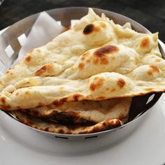 some pita bread in a bowl on a plate