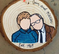 a wooden ornament with an image of two men hugging each other on it